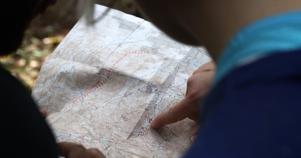Person pointing on map.
